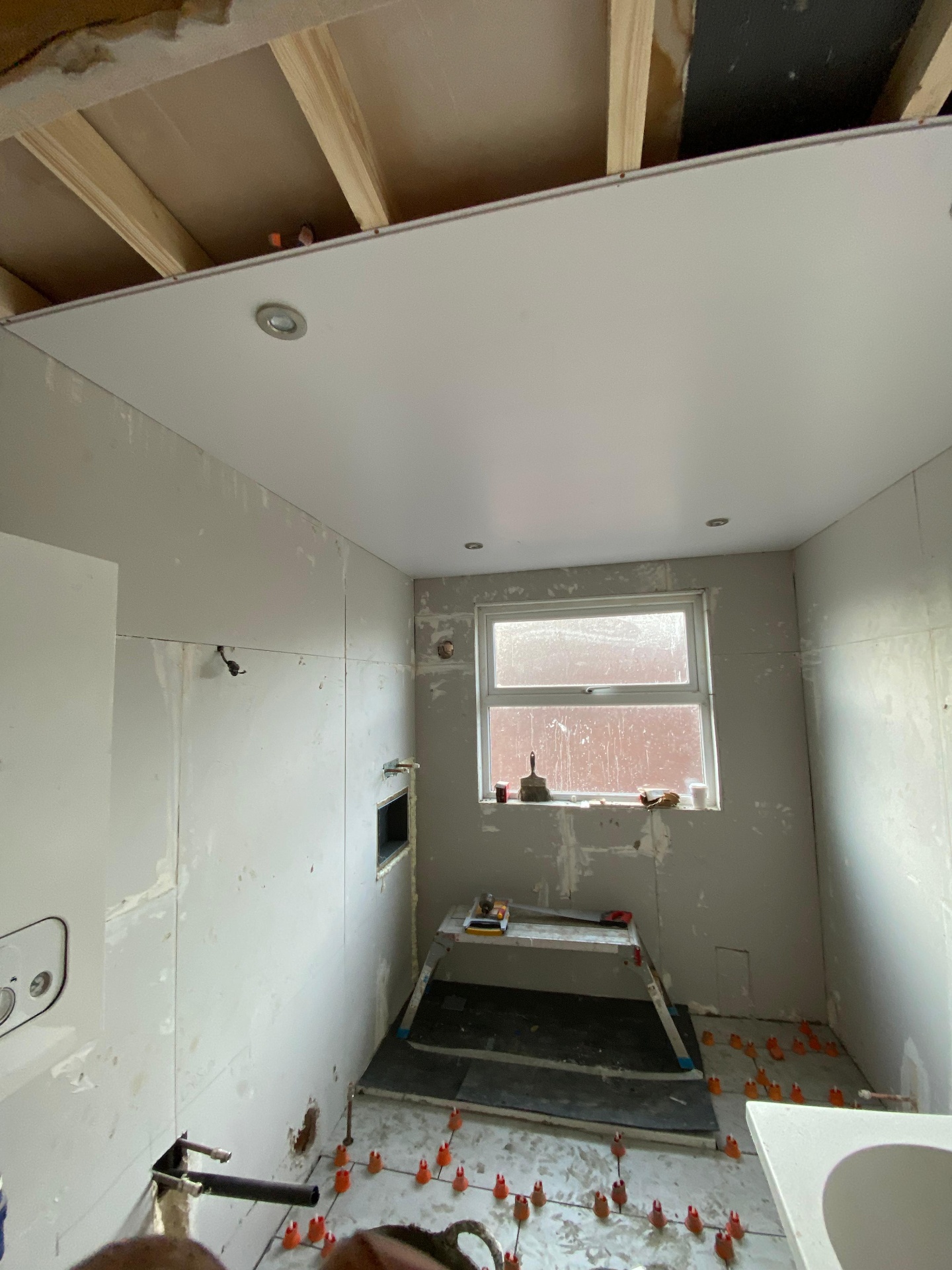 Bathroom mid-build — boarding & tiling